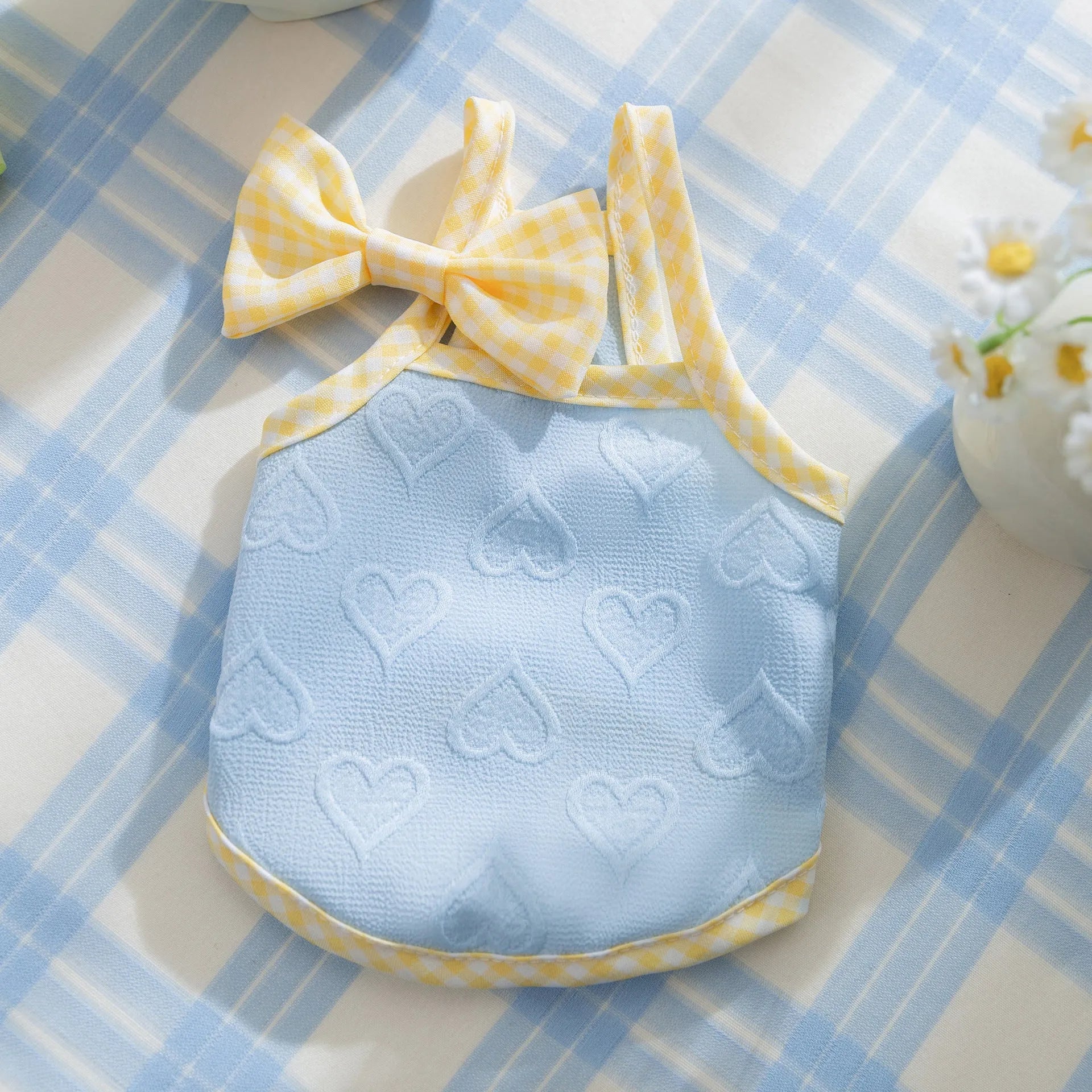Small dog wearing heart texture vest with bow suspenders in Bondi Blue