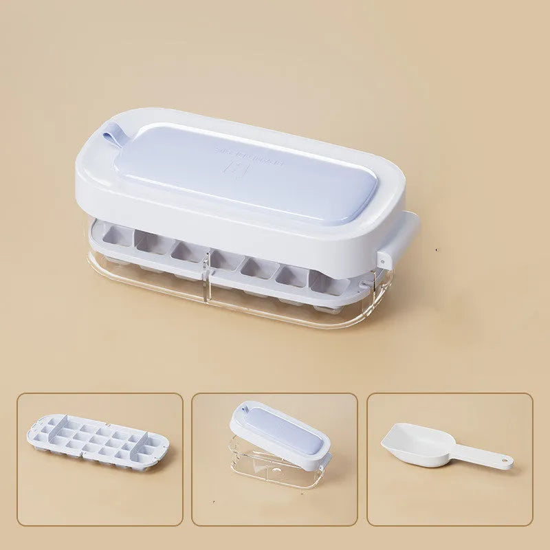 High capacity blue ice cube tray with ice grid and attached storage for the included shovel.