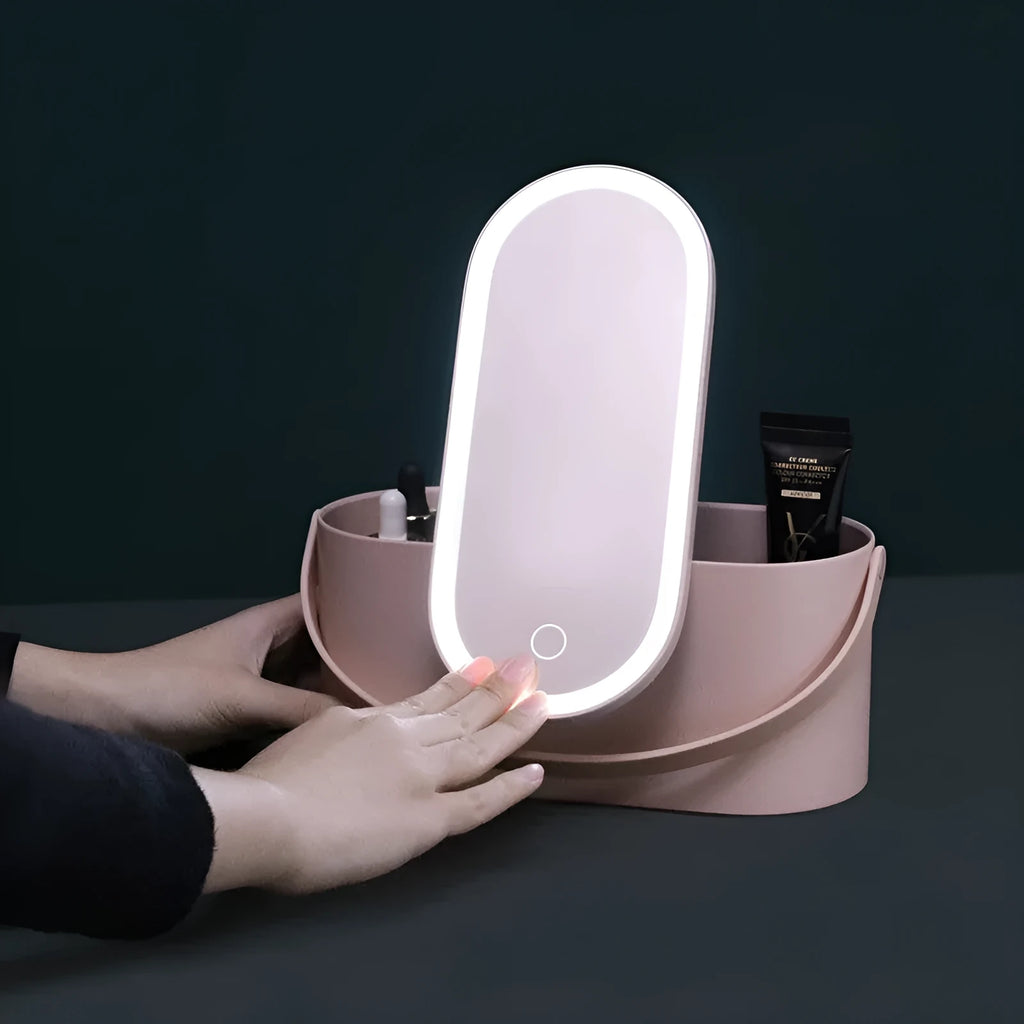 Portable LED light storage box beauty and makeup mirror with aluminium mirror lens in pink colour on a bedroom surface.