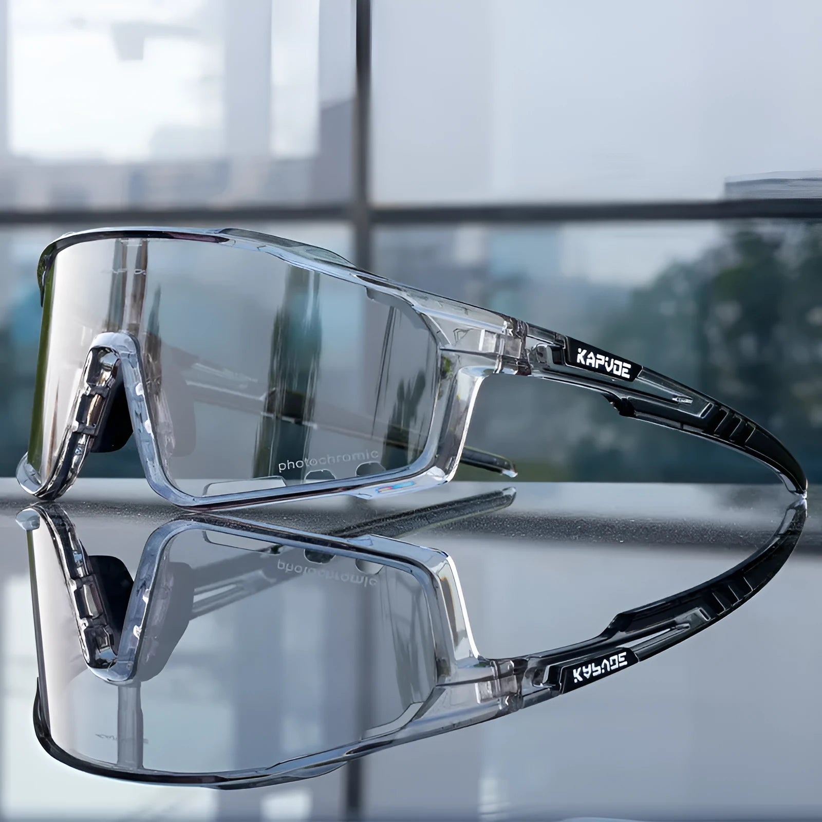 Close-up of photochromic cycling goggles with TR90 frame and semi-rimless design on a handlebar.