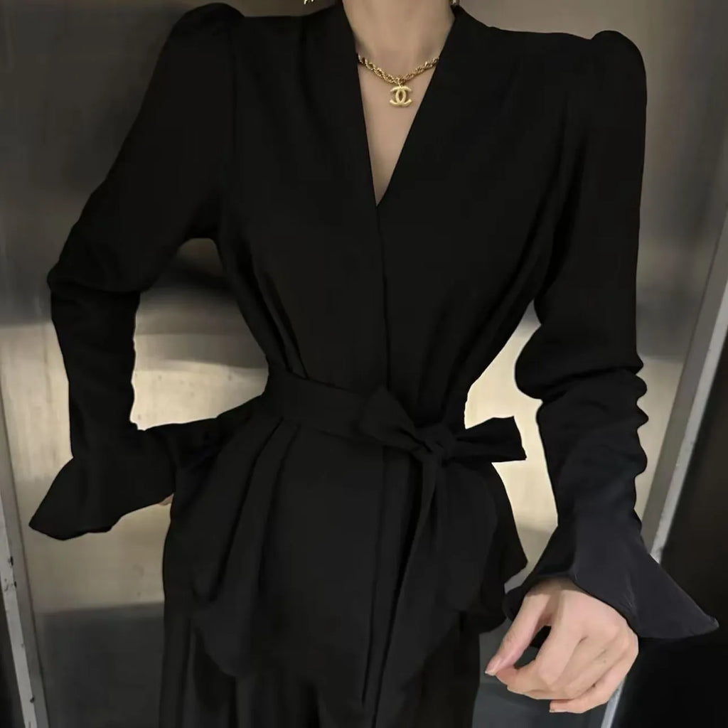 Women's black French-style shirt with irregular collar and long tied bell sleeves.