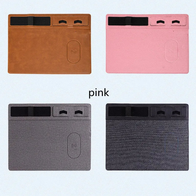 Pink wireless charging mouse pad with phone holder on a desk, showing USB cable and 320mm x 260mm size.