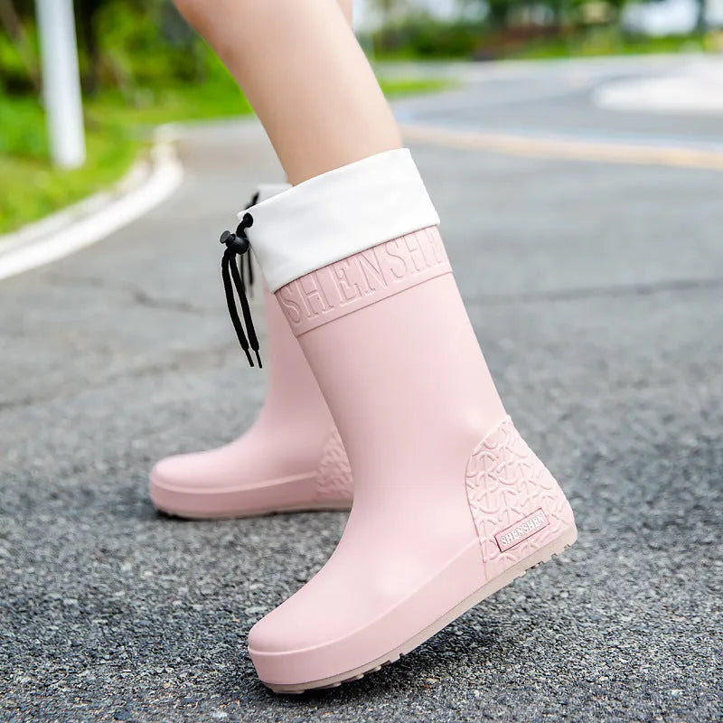 Women's solid colour PVC rain boots with non-slip soles in apricot, black, brown, and pink options