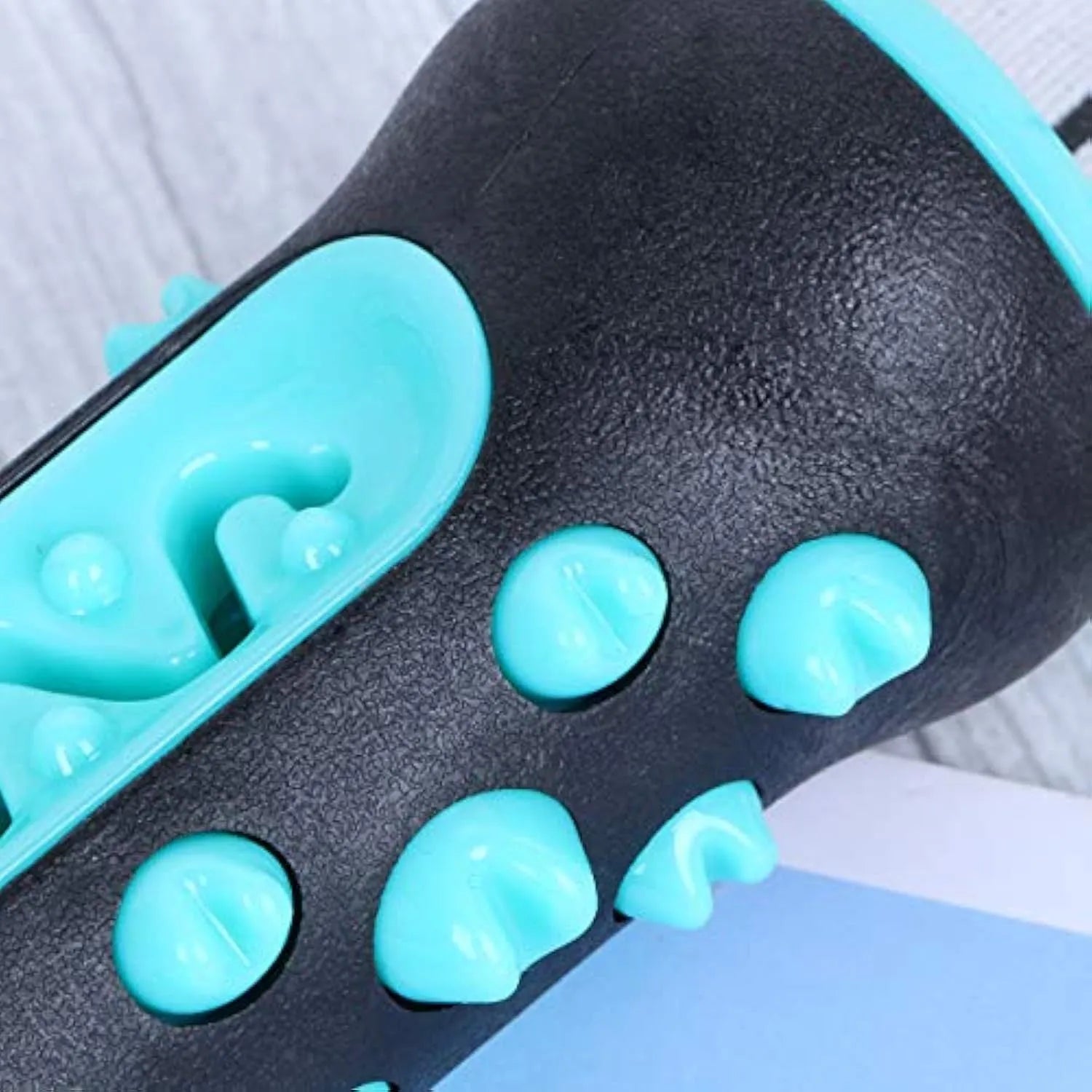 Natural rubber dog dental chew toy in blue, green, yellow, and black blue colours.