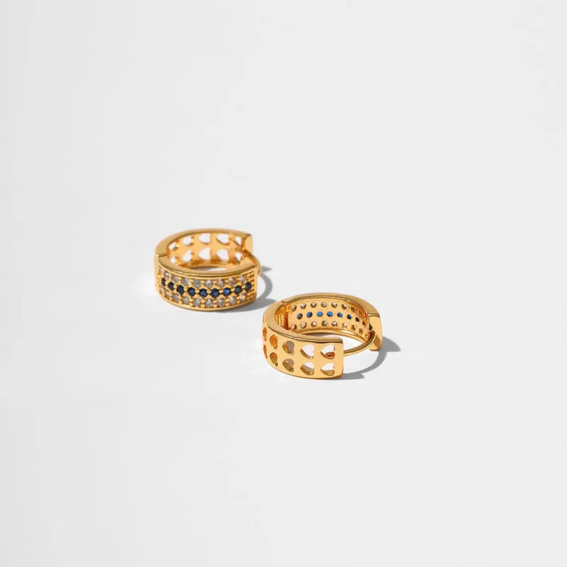 A pair of round, geometric copper earrings with an 18K electroplated gold-colour finish.