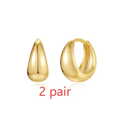 Brass geometric earclip earrings with gold electroplated finish and round design elements