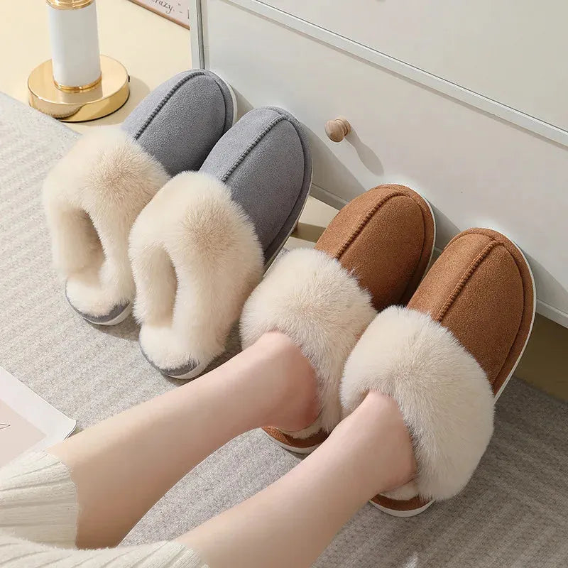Women's plush winter slippers in grey with a round toe, flat heel, and non-slip PVC sole.