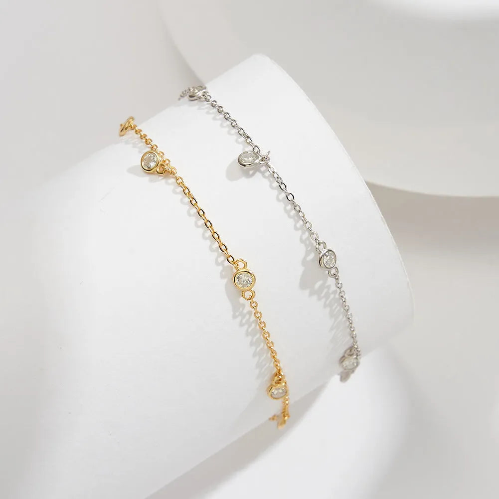 Women's silver geometric anklet with a small zirconium pendant, shown in gold and white gold colour options.