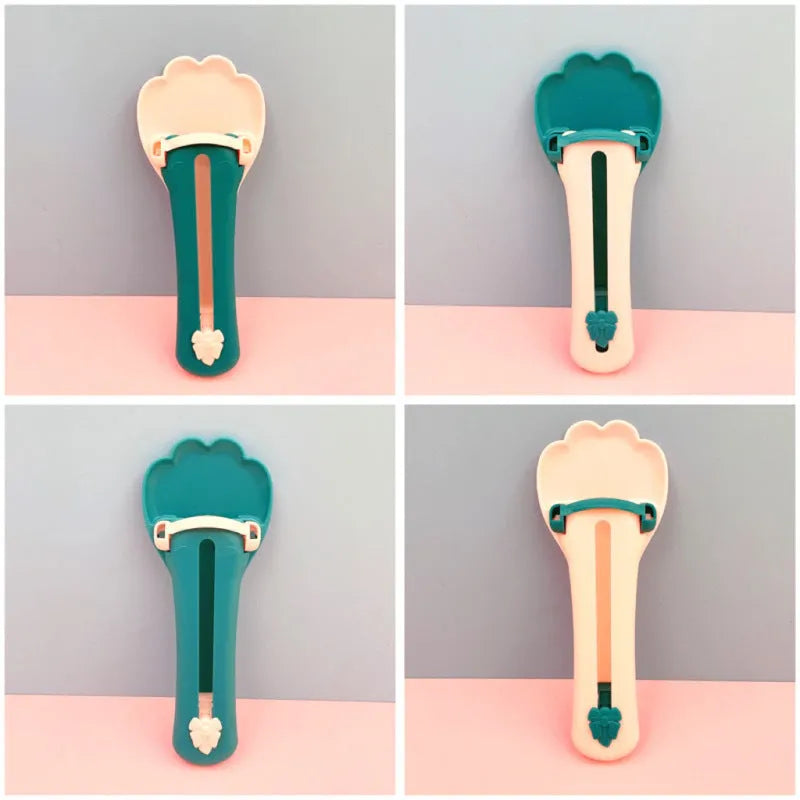 Green and pink pet food squeezer spoon for dispensing treats and liquid food to cats and dogs.