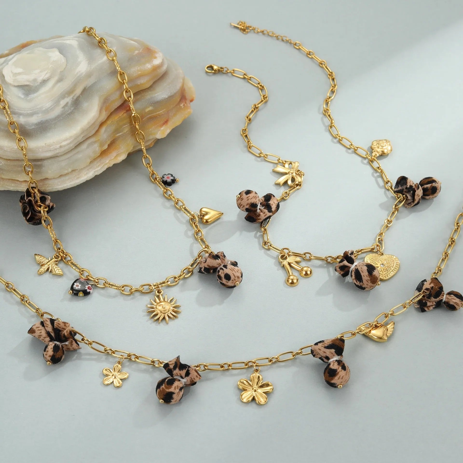 Leopard and love heart flowers pendant necklace on a stainless steel chain with gold electroplating.