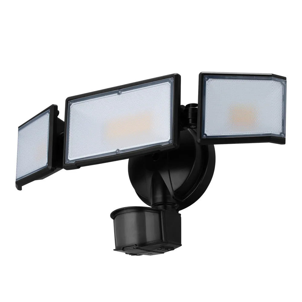 White outdoor LED security flood light with motion sensor mounted on a wall.