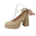 Women's beige Mary Jane shoes with chunky heel and ankle strap buckle showing round toe design