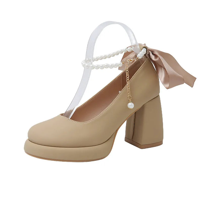Women's beige Mary Jane shoes with chunky heel and ankle strap buckle showing round toe design