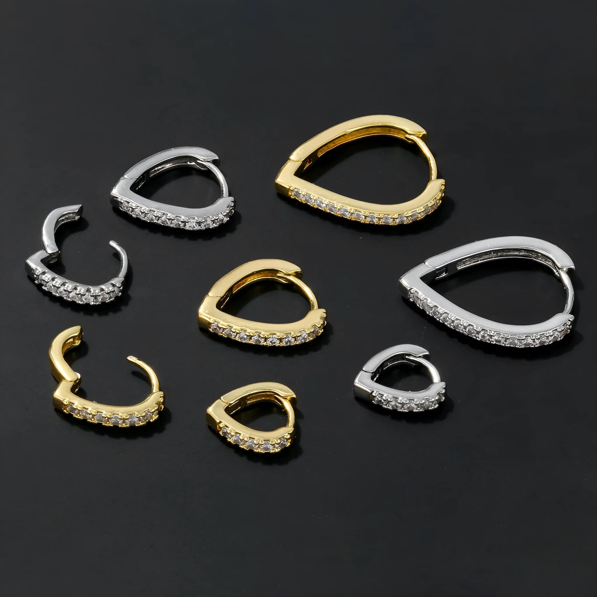 Geometric heart-shaped copper ear clip with electroplated gold or white finish on a white background.