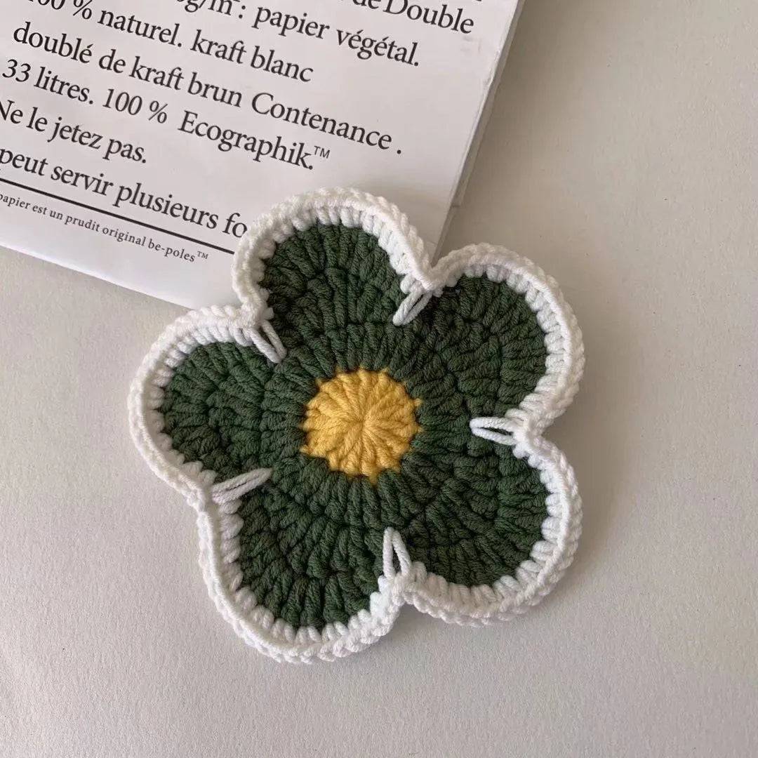 Handmade woven flower placemat set of five round polypropylene table mats in blue, green, orange, pink, and purple.