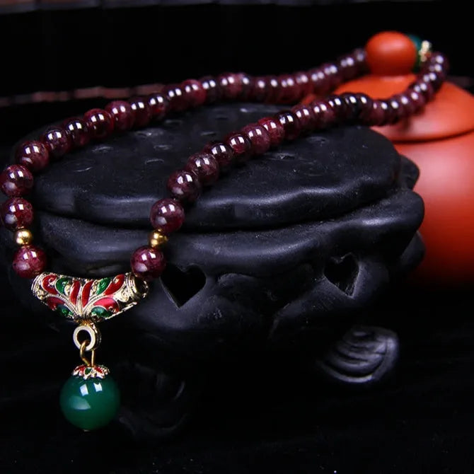 Natural garnet bracelet with 7mm stones, double ring settings and golden toad charm