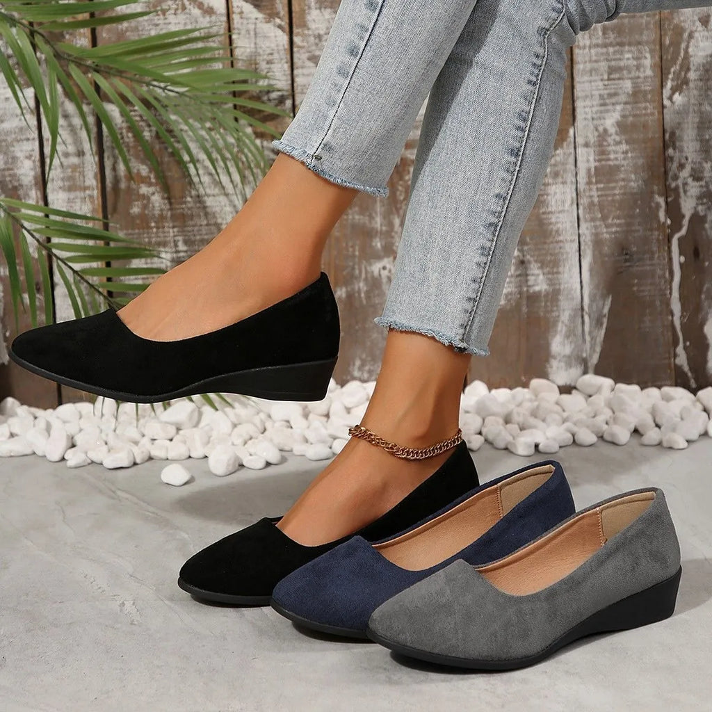 Women's pointed toe suede wedge pumps with a low heel and shallow V-cut opening in multiple colours.