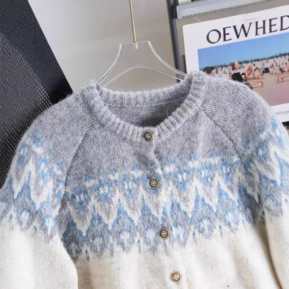Women's loose-fit jacquard knit sweater coat in milky white, shown on a hanger.