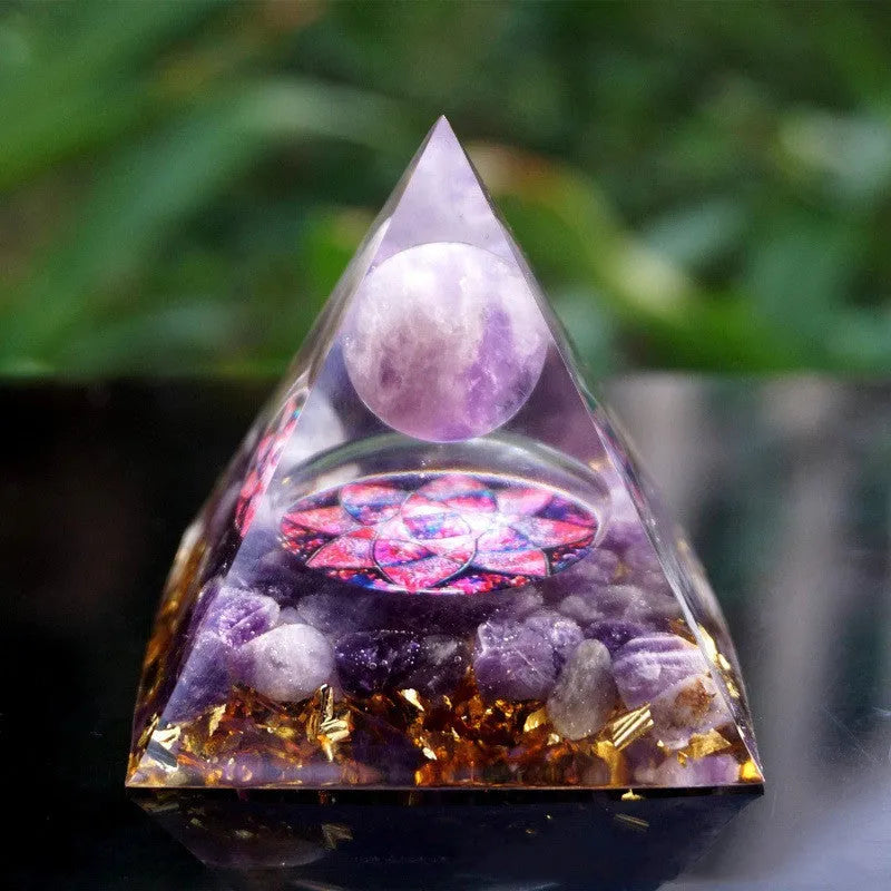 A clear 6cm tall epoxy resin pyramid hanging ornament for displaying crystals.