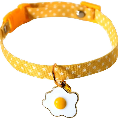 Adjustable green pet collar with a metal bell and pink bow tie on a small dog.