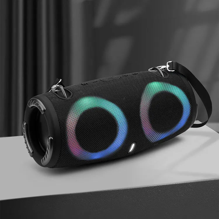 War Drum portable Bluetooth speaker with RGB coloured lights in black, showing built-in strap and control buttons.