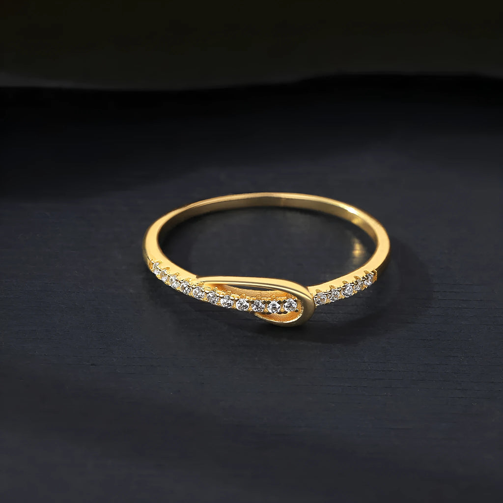 S925 silver bow ring with single row of diamond stones on a plain background