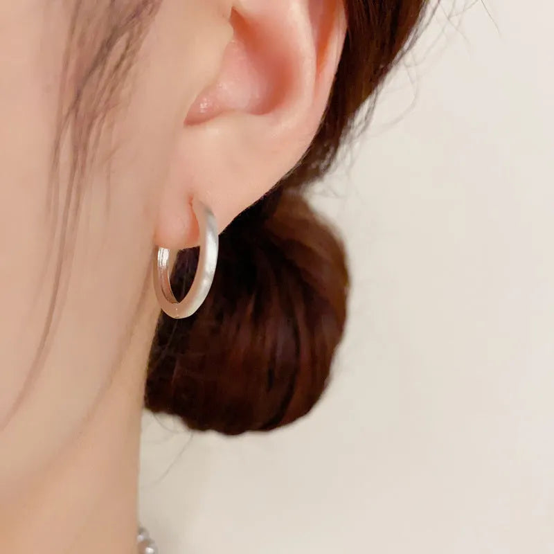 A pair of round geometric clip-on earrings for women in gold or silver plating.