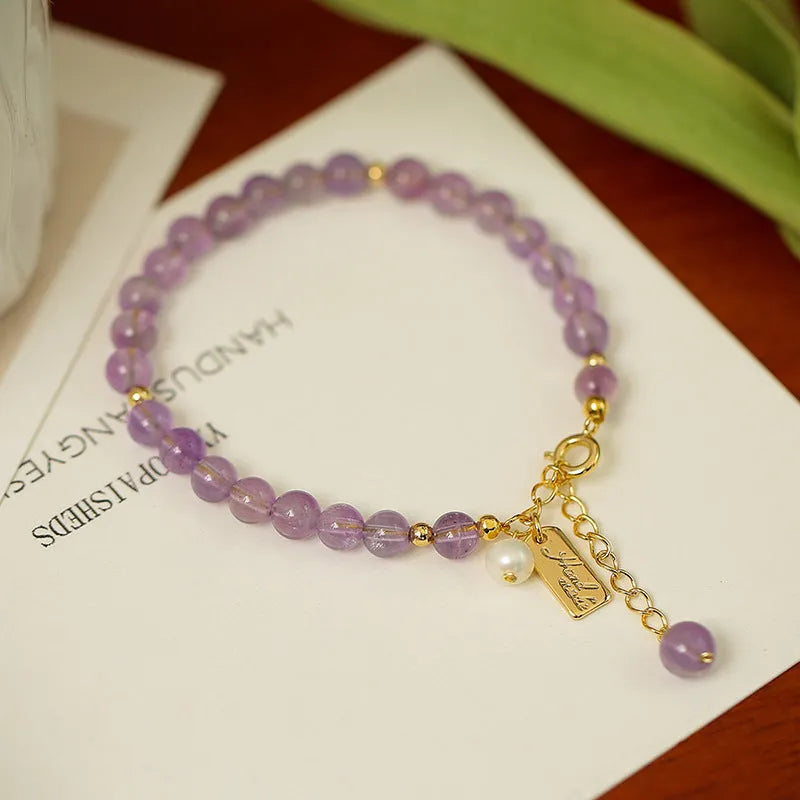 Natural crystal lavender amethyst bracelet for women in dark and light colour variations on a wrist.