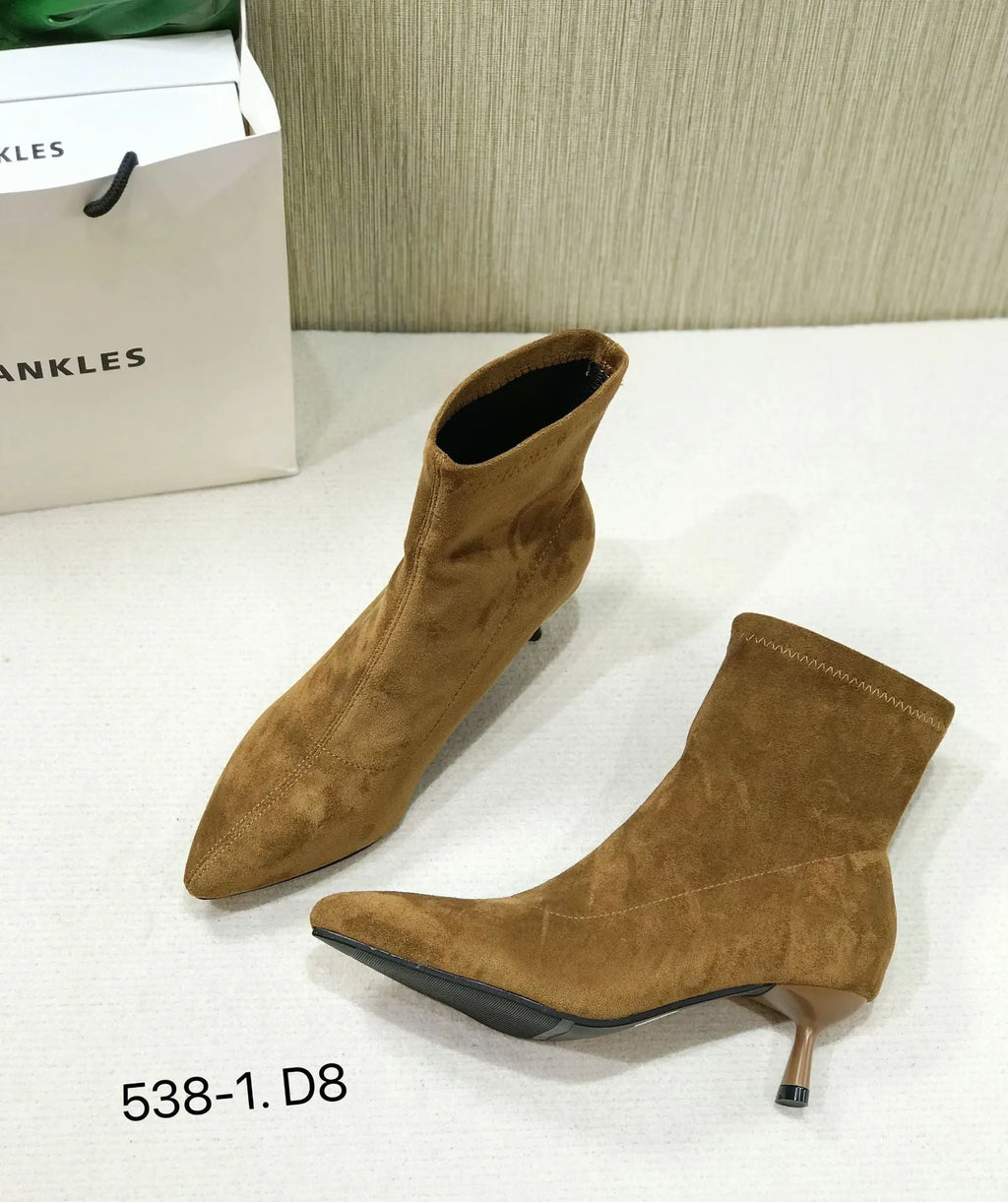 Women's black pointed toe ankle boots with a stiletto heel on a rubber sole.
