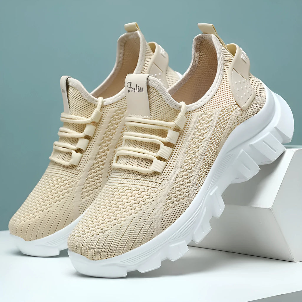 Women's white Flyknit running sneakers with thick PVC sole and lace-up front.
