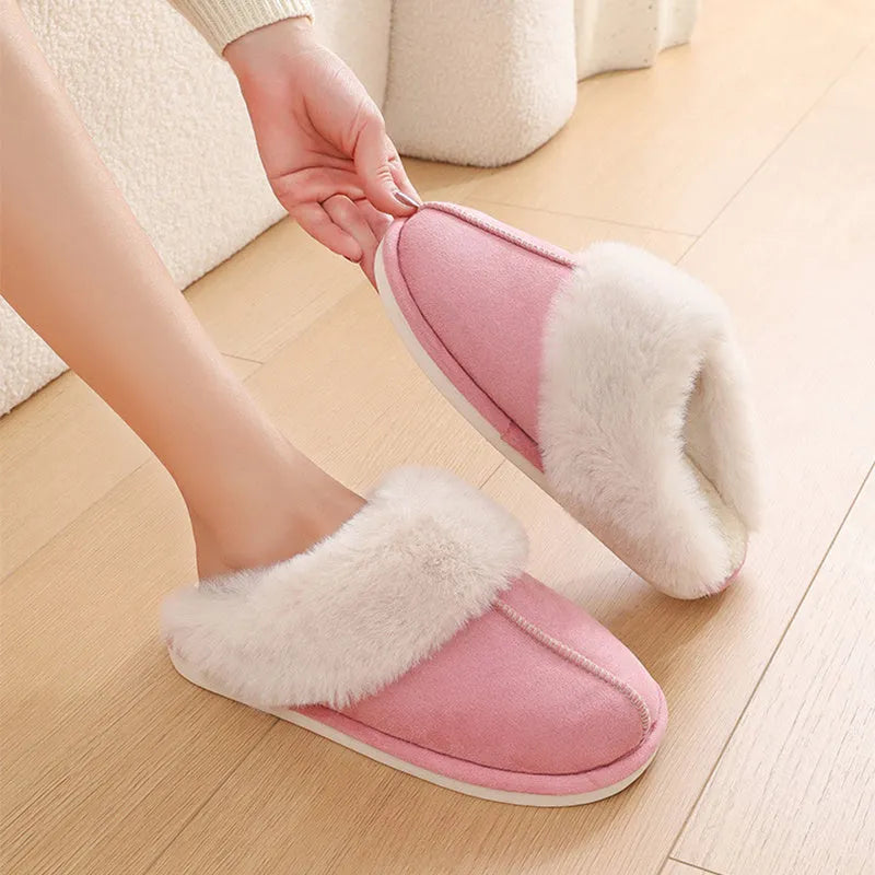 Women's plush winter slippers in grey with a round toe, flat heel, and non-slip PVC sole.