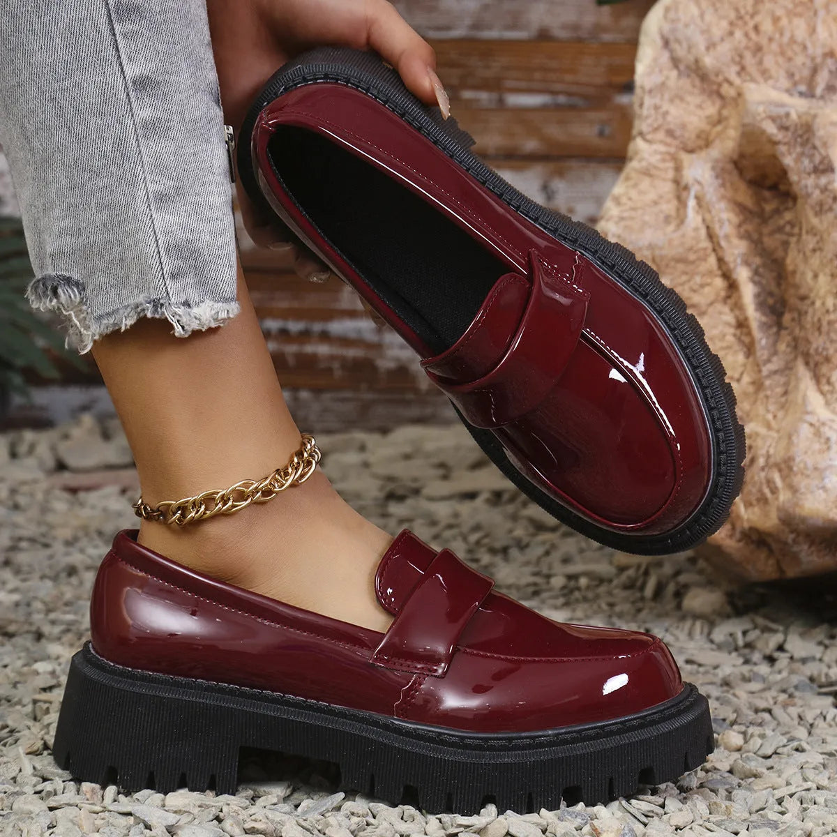 Black chunky heel loafers with a thick rubber sole and platform, shown from the side.