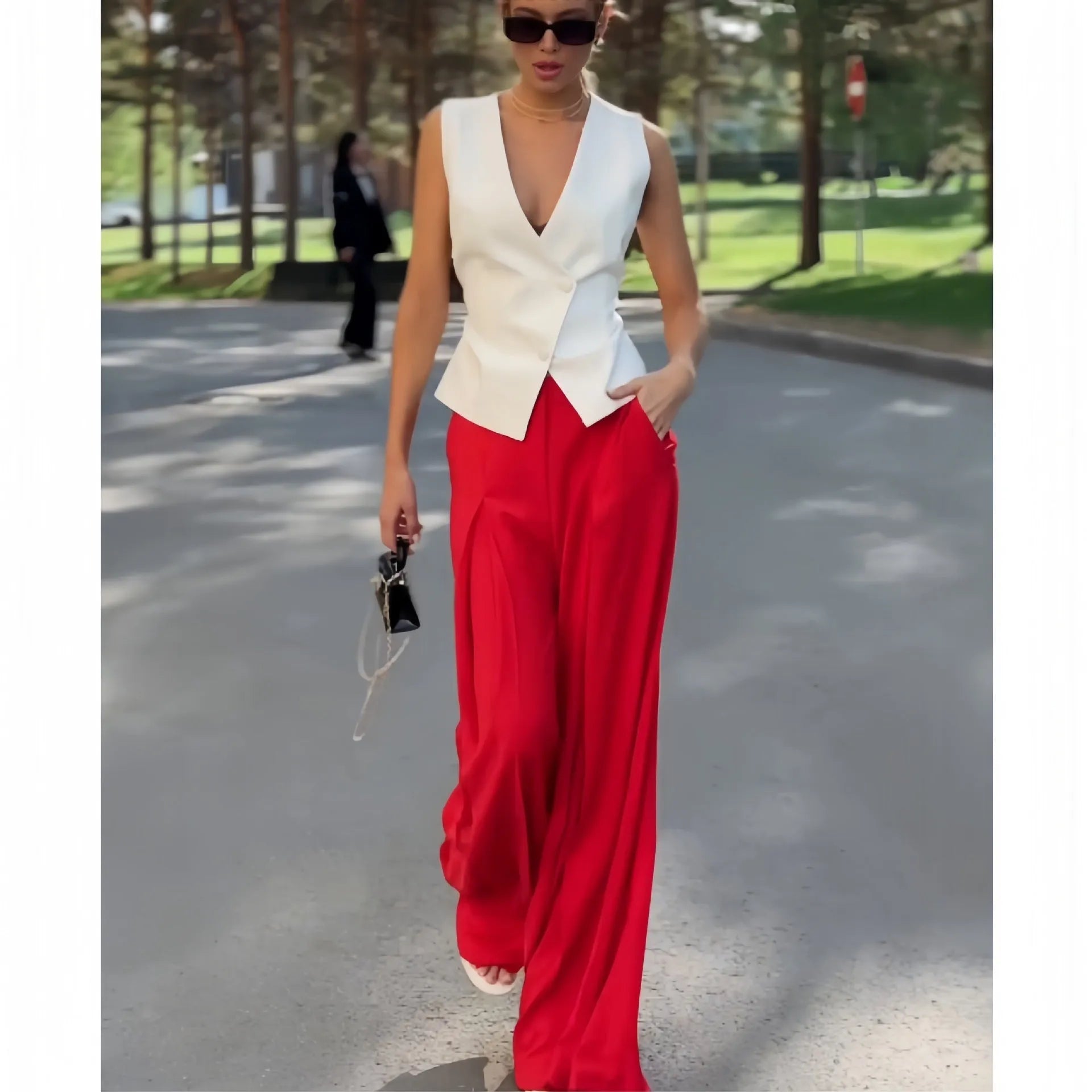 Beige women's two-piece set with sleeveless V-neck top and wide-leg trousers on a hanger.