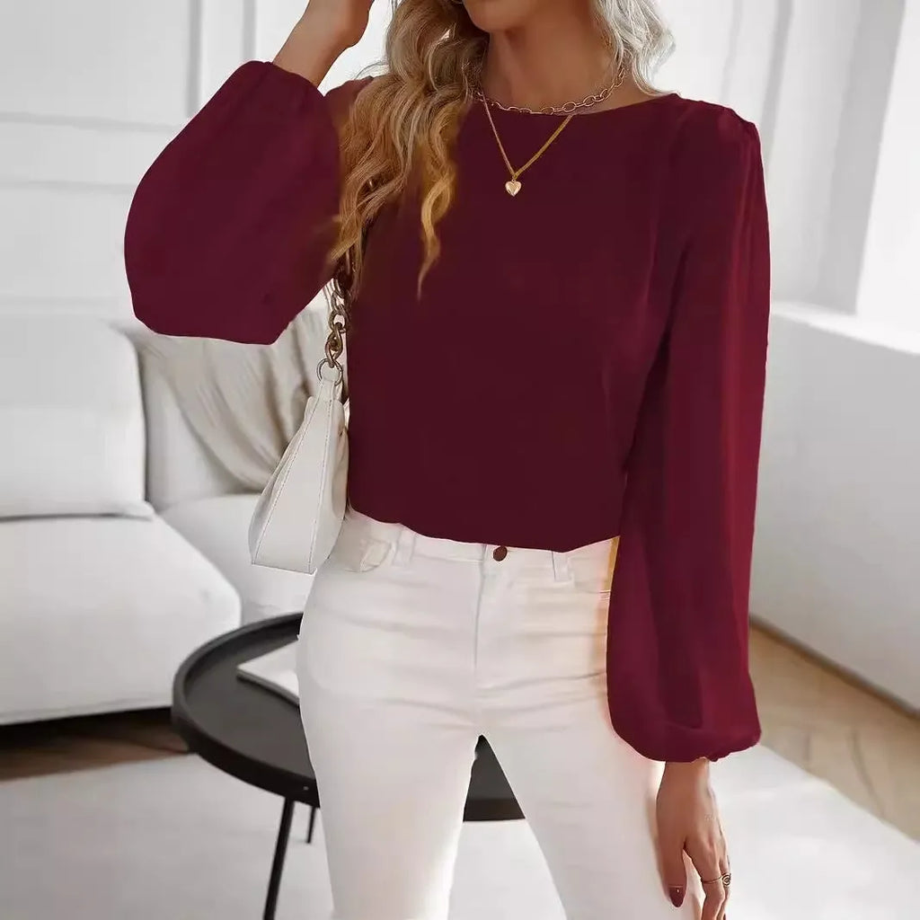 Wine red women's solid colour round neck long sleeve polyester top with button front, shown on a model.