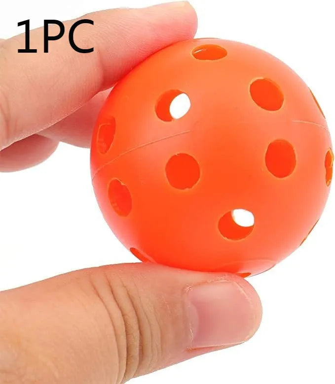 Multi-coloured golf practice balls in net storage pocket for putting training