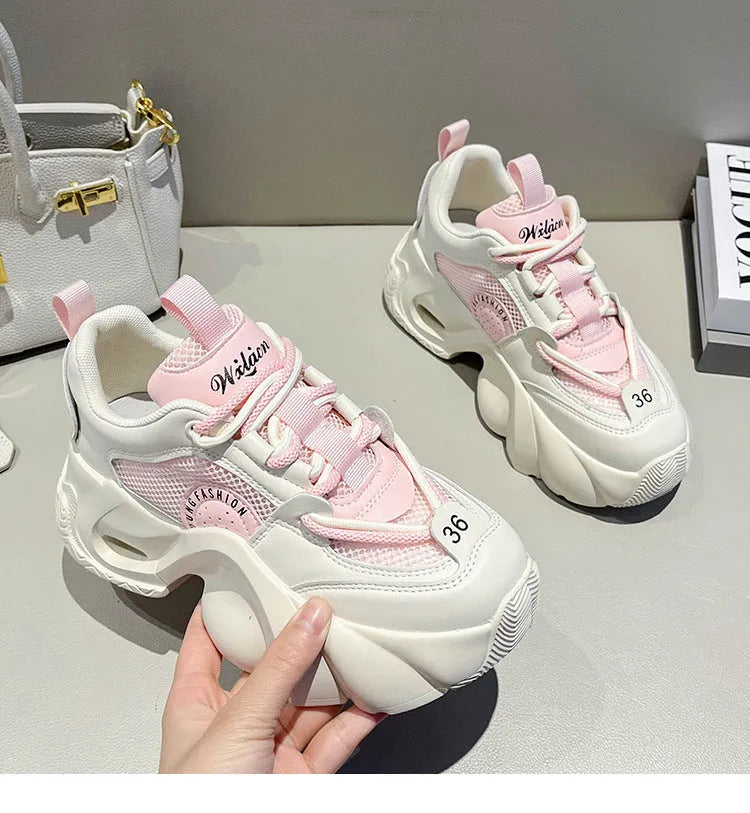 Women's beige sneakers with a thick rubber sole, cross ankle strap, and mesh lining.