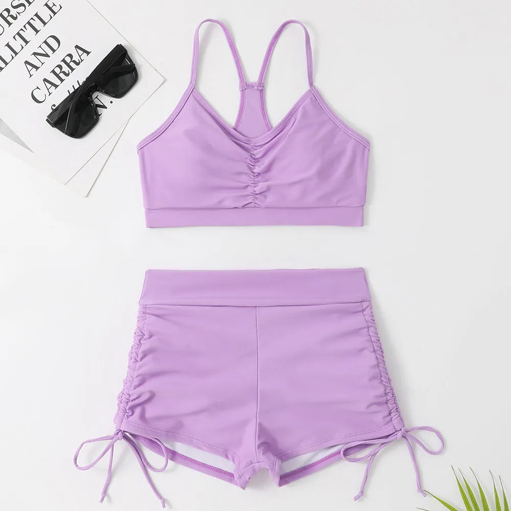 Women's black and violet high waist split bikini swimsuit for surfing and swimming.
