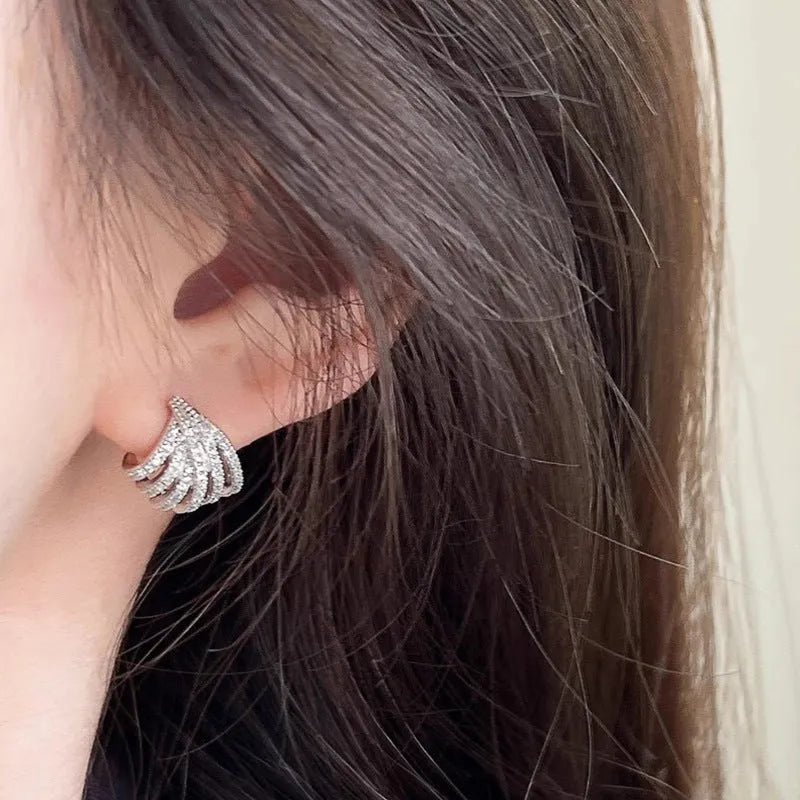 A pair of geometric-shaped earrings with a line design, made from zircon with an electroplated platinum finish.