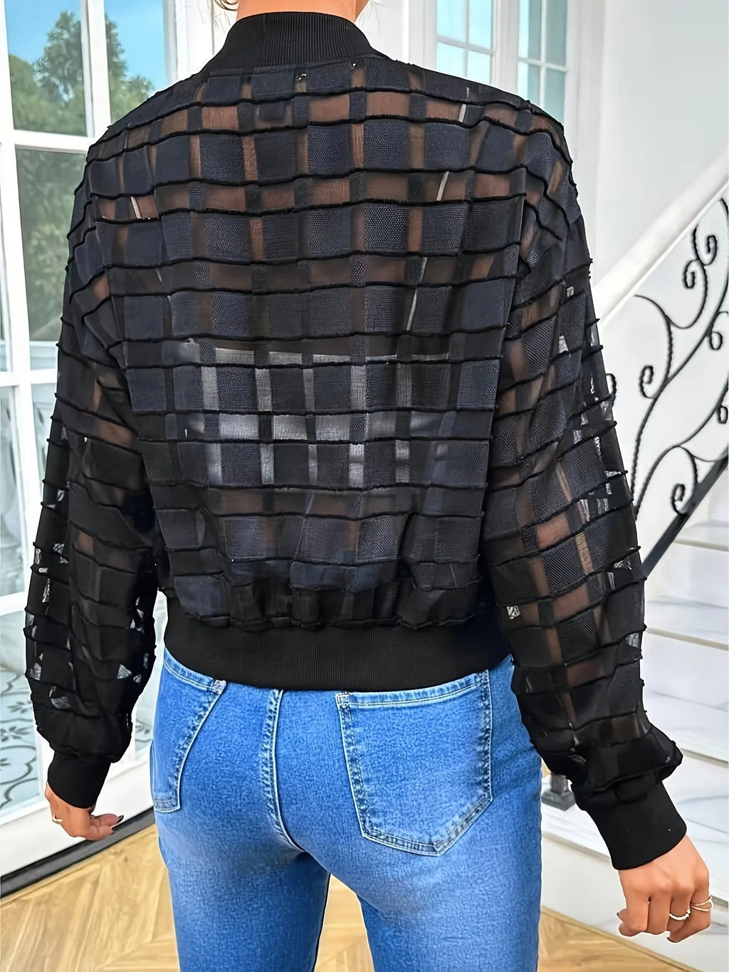 Black women's casual jacket with geometric pattern on semi-transparent fabric and threaded zipper.