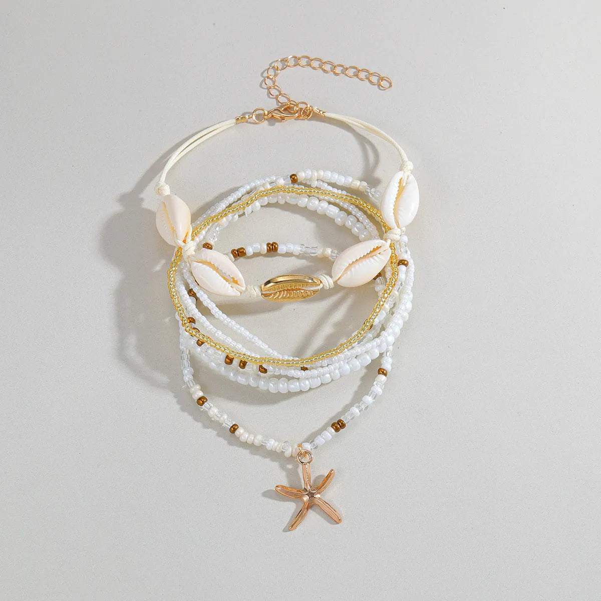 Seven-piece women's anklet set with starfish pendant, shell and rice bead details on woven wax thread, colour XY-4358