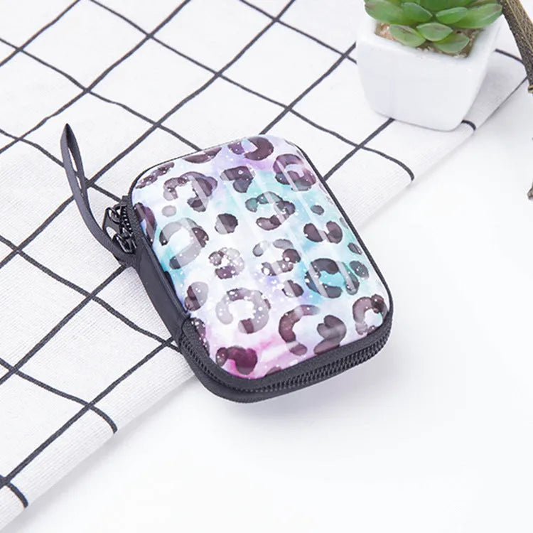 Tinplate coin purse with anime cartoon pattern, letter details, horizontal square shape, and zipper opening.