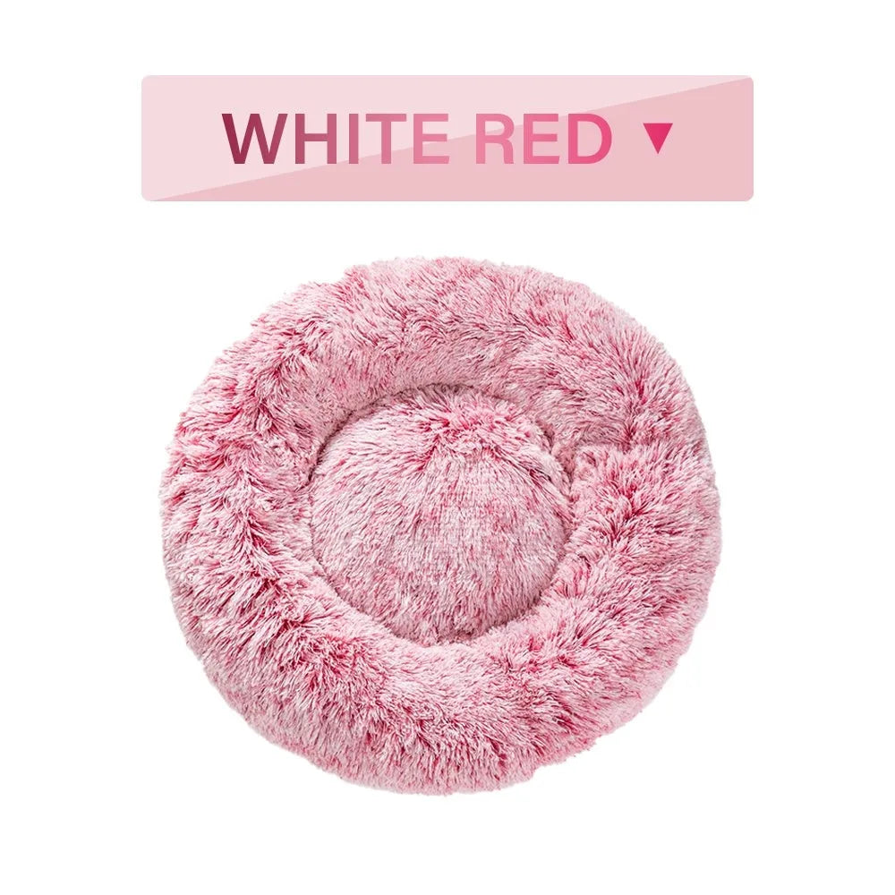 Fluffy donut-shaped dog bed in light grey plush material, showing raised rim and central cushion.