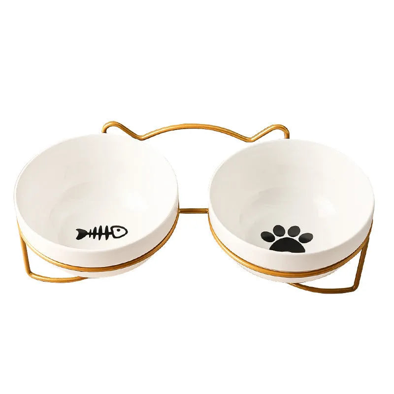 White ceramic cat bowl with paw print design in a black iron cat-ear frame.
