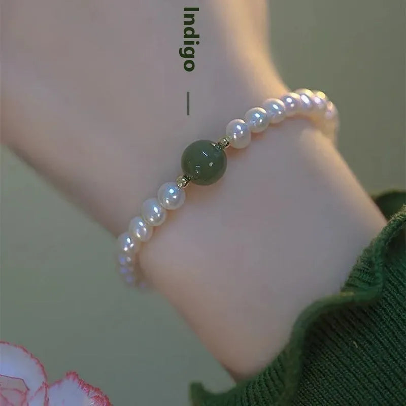 Chinese style glass bead bracelet with bamboo leaf design and manual craftsmanship details.