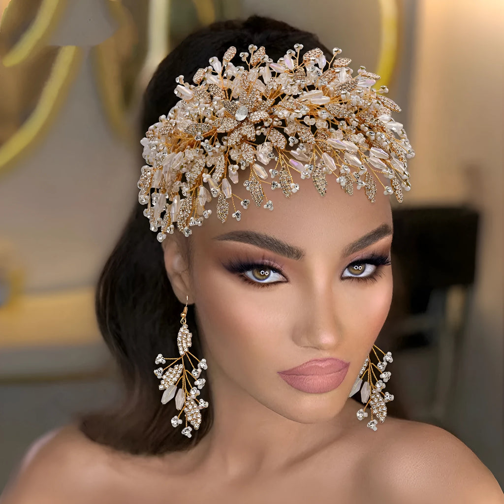 Gold rhinestone wave bridal headpiece and matching earrings set on display