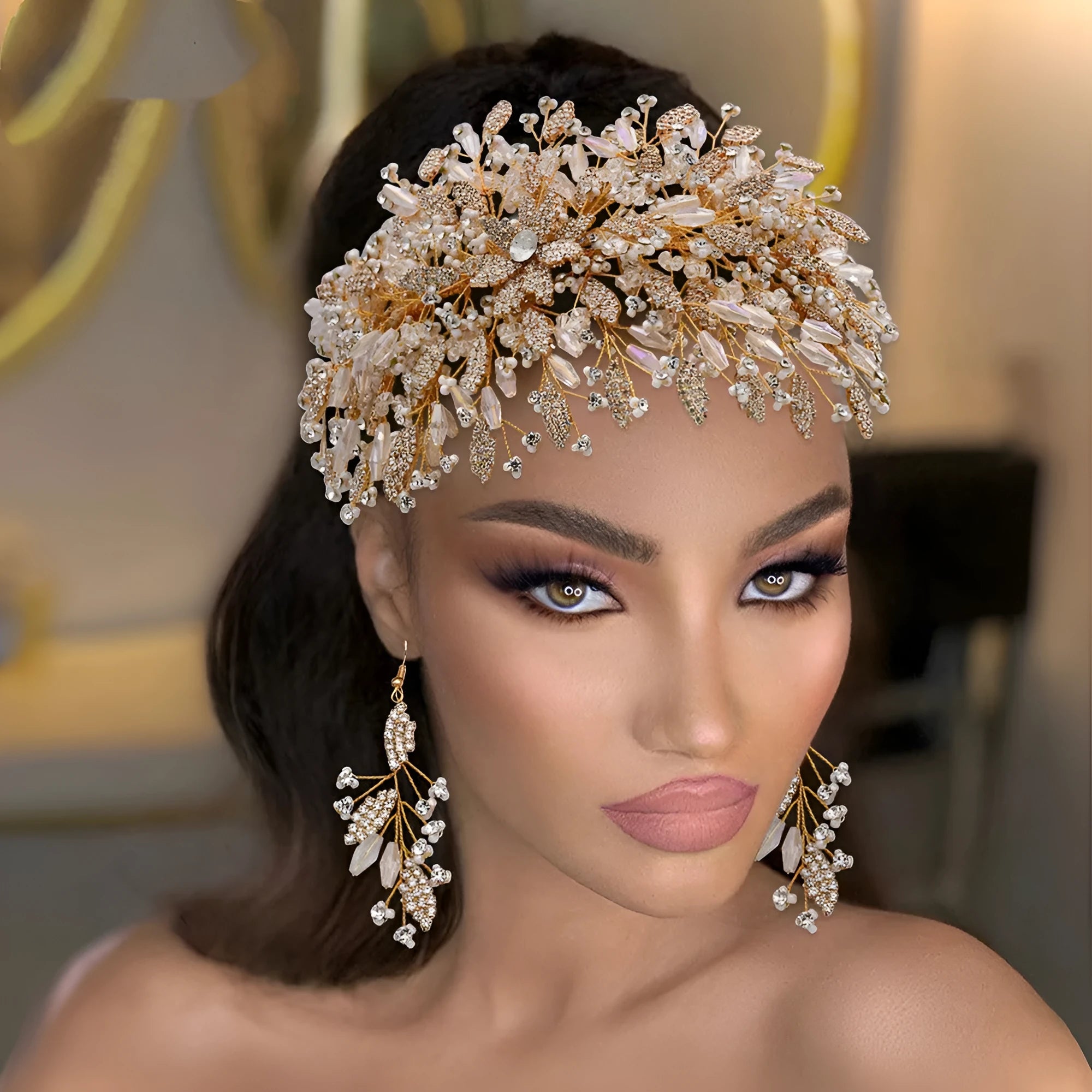 Gold rhinestone wave bridal headpiece and matching earrings set on display