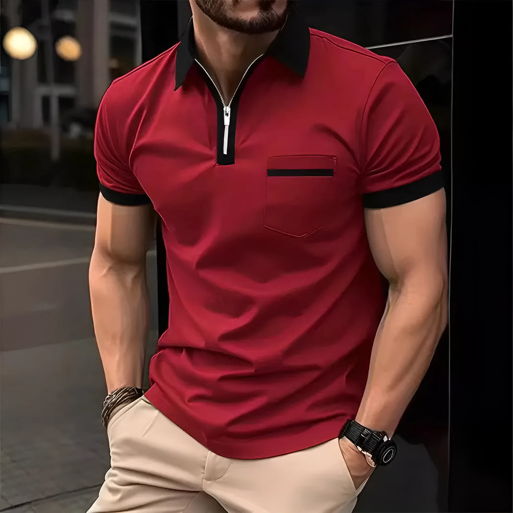 Man wearing a loose-fit casual short-sleeved shirt with a chest pocket and zipper decoration details.
