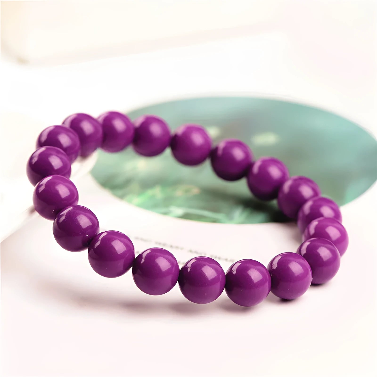 Jiuya polished purple mica crystal bracelet shown in three bead size variations on a wrist.