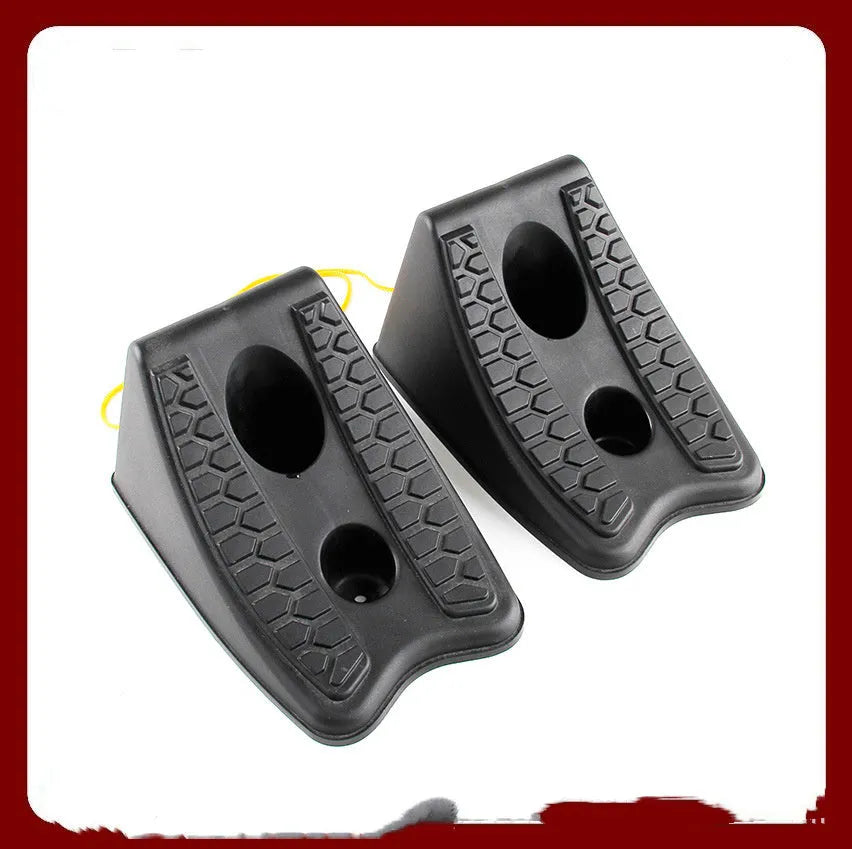 Pair of black wedge-shaped rubber car wheel stoppers with arc bevel and anti-slip base