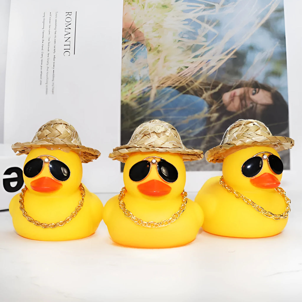 Yellow cartoon duck with straw hat car ornament on dashboard with sunglasses accessory